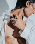 man applying dreamer lasting fragrance by tifmo