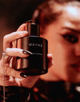 woman grabbing sexy and winter perfume bottle