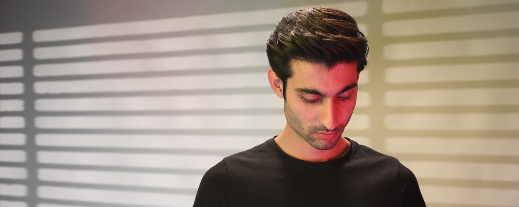 Man looking downwards, showing hairstyle