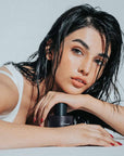 woman laying with summer perfume under her chin