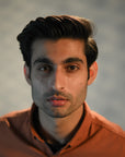 Pomade hairstyle by a man with firm hair, wet look