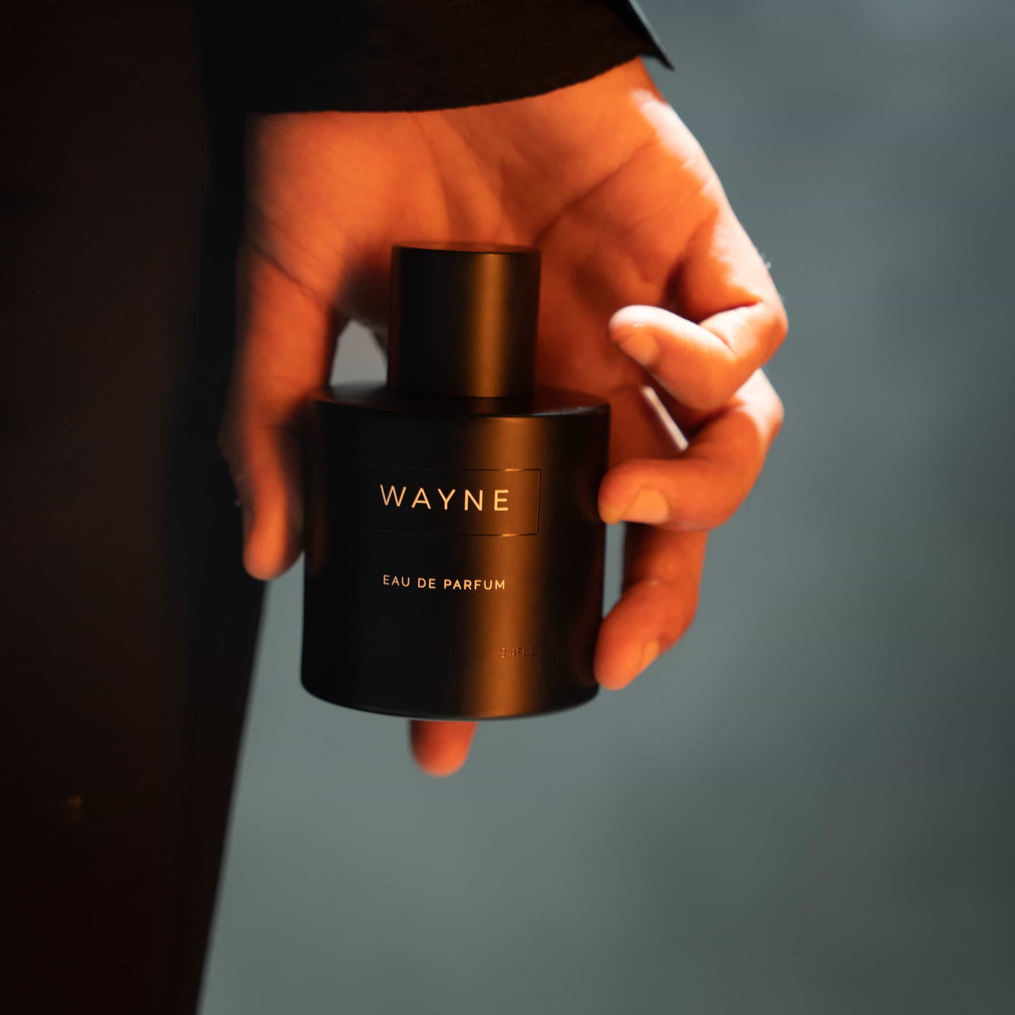 wayne fragrance bottle in hand